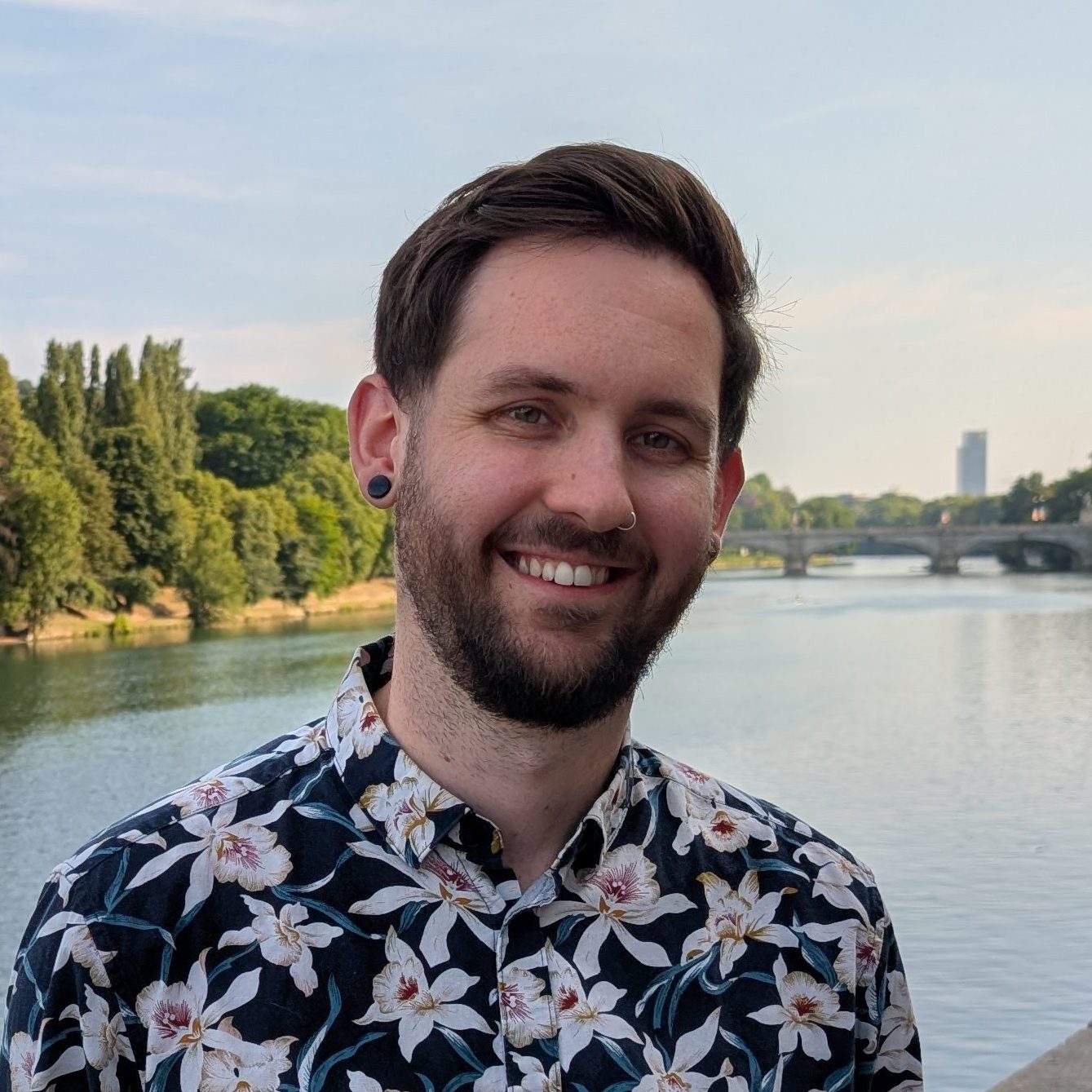 Headshot of Ryan, a white man in his 30s with brown hair and a brown beard